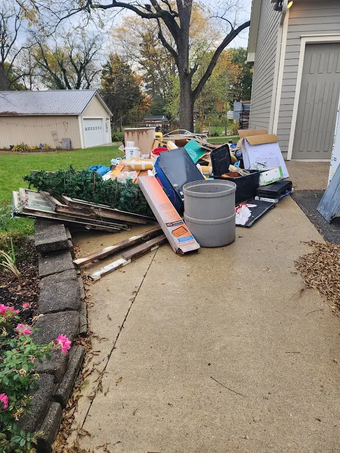Dumpster being loaded with debris for Estate Cleanout Dumpster Rental in Whiteland